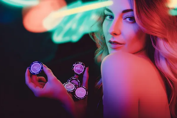 A glamorous woman holding casino chips in a neon-lit environment, representing the premium online casino atmosphere of 1111BED.